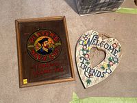 Players Navy Cut tobacco mirrored sign framed with an illustration of a sailor and colored text alongside the Welcome Friends heart-shaped floral wooden art piece.