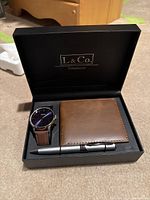 L&Co. Timepieces gift set including watch, brown leather wallet, and silver pen in black box