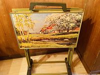 Folding table with spring landscape painting and barn