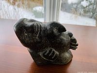 Front-angled view showing seal’s head with carved flippers and underside details