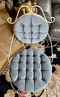 Top-down view of the boudoir chair showing the tufted blue velveteen seat and back cushions on the off-white wrought iron frame with curling details.