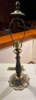 Full view of the vintage cast metal table lamp showing the overall height including finial and harp.