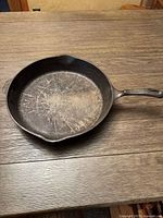 Top-down view of the Wagner 1891 cast iron skillet showing the cooking surface with some seasoning marks and use wear.