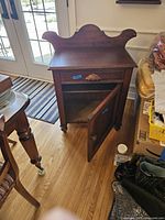 Front angle showing the washstand with open door and drawer.