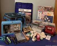 Wide view showing the collection of punches, storage box, magazines, and other craft tools.