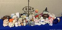 Full table view showing forty assorted pig-themed items including figurines, piggy banks, and salt and pepper shakers.