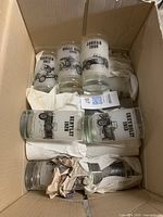 All seven Pioneer glasses with vintage black car illustrations and years inside a box, some wrapped in paper padding