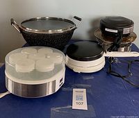 Overall view of the four small appliances and accessories on a table