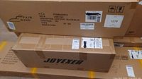 Boxes of FAIR WIND Loveseat chair and Joyexer air mattress stacked