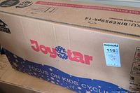 Cardboard box with Joystar logo and blue/pink color branding, showing branding and bike SKU on side label