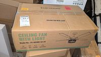 Box of Luminfan ceiling fan with light showing model number FS-8836D-52-01, packaging indicating six speeds, timer, and smart controller