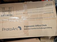 Photo of the sealed box showing ProtoArc logo and ergonomic office chair branding