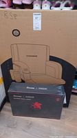 Boxed VIVOHOME stadium seat and Govee x Evangelion gaming wall light boxes stacked.