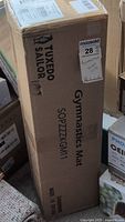Box showing Tuxedo Sailor branding and model number SOP7ZZ1GK1M1 labeled as a gymnastics mat