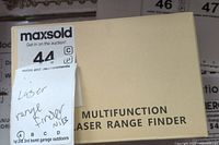 Box of the multifunction laser rangefinder labeled 'NIB' (new in box).