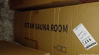 Cardboard box labeled 'STEAM SAUNA ROOM' with MaxSold auction label