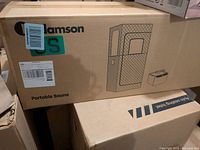 Box of Adamson portable sauna showing branding and simple line drawing of sauna design.