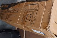Box showing a sketch of the trampoline with enclosure and description as domestic fitness exercise trampoline.