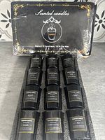Packaging of 12 Eupnhy scented candles, black and gold with elegant design.