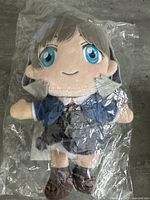 Front view of new Anima plush doll with blue eyes and school uniform, sealed in plastic packaging.