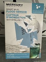 Front of the sealed box showing the brand, product name, and water alert features.