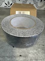 Photo of the roll of stair anti slip tape showing the round side with visible gritty texture and tightly rolled tape.