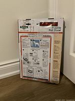 Photo of the back of the PetSafe Plastic Pet Door box showing installation instructions and features.