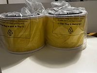 Two new PUREBURG HEPA replacement filters sealed in clear plastic with yellow pleated filter media visible.