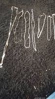 7 silver tone chains laid out on black background for viewing and condition assessment.