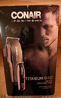 Box of Conair Titanium 640 men's beard/hair trimmer and detail trimmer set, showing front packaging with male model.