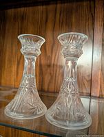 Photo of two crystal candle holders with detailed floral etching