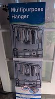 Photo of a boxed multipurpose clothes hanger showing clothing racks and a base shelf, weight capacity 48kg