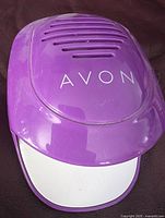 Purple Avon battery nail dryer with ventilation slots shown on surface.