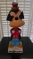 Front view of the ceramic Goofy nodder showing the figure standing on a base with 'Walt Disney World' text and logo.
