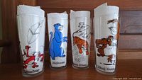 All four Jungle Book character drinking glasses together showing designs of Mowgli & Baloo, Bagheera, Shere Khan, and King Louie.