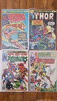 Four vintage Marvel comic books showing front covers of The Human Torch, Thor, and two Avengers comics arranged in a 2x2 grid.