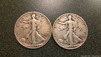 Obverse side of 1942 and 1944 Walking Liberty half dollar coins showing the front design with Walking Lady figure walking towards the sunlight, dates visible at bottom