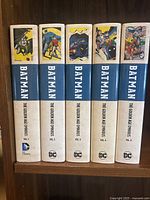 Spines of Omnibus Volumes 1 to 5 on a shelf