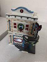 Front right angle showing facade with “Comics New & Used,” wreath and marquee sign