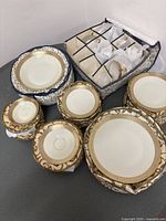 Padded storage cases containing plates, saucers and cups, organized in zippered holders