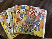 Seven vintage Dell Comics arranged fanned out showing colorful covers featuring Looney Tunes, Casper Cat, and other characters.