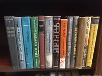 Front view of all book spines arranged side by side showing set of hardcover novels