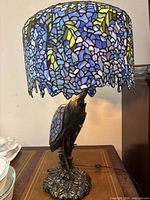 Full view of lamp showing shaded top and bird base