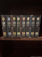Eight slipcased volumes on shelf, spines showing date ranges