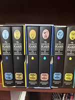 Front view showing six hardcover Peanuts comic volumes with character portraits and years 1987-1998.