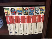 Spine view of seven volumes showing titles and volume numbers