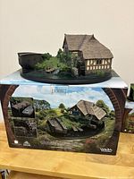 Front view of diorama displayed on original box packaging showing entire Hobbiton Mill and Bridge scene.