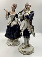 Pair of figurines, front view showing both male and female on decorative bases