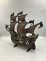 Full view of the cast iron galleon ship door stop showing the full structure and shape with three sails, the prow, and rear stern detail.