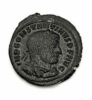 Obverse side of coin showing right-facing portrait of Constantine I with laurel wreath and surrounding inscription.